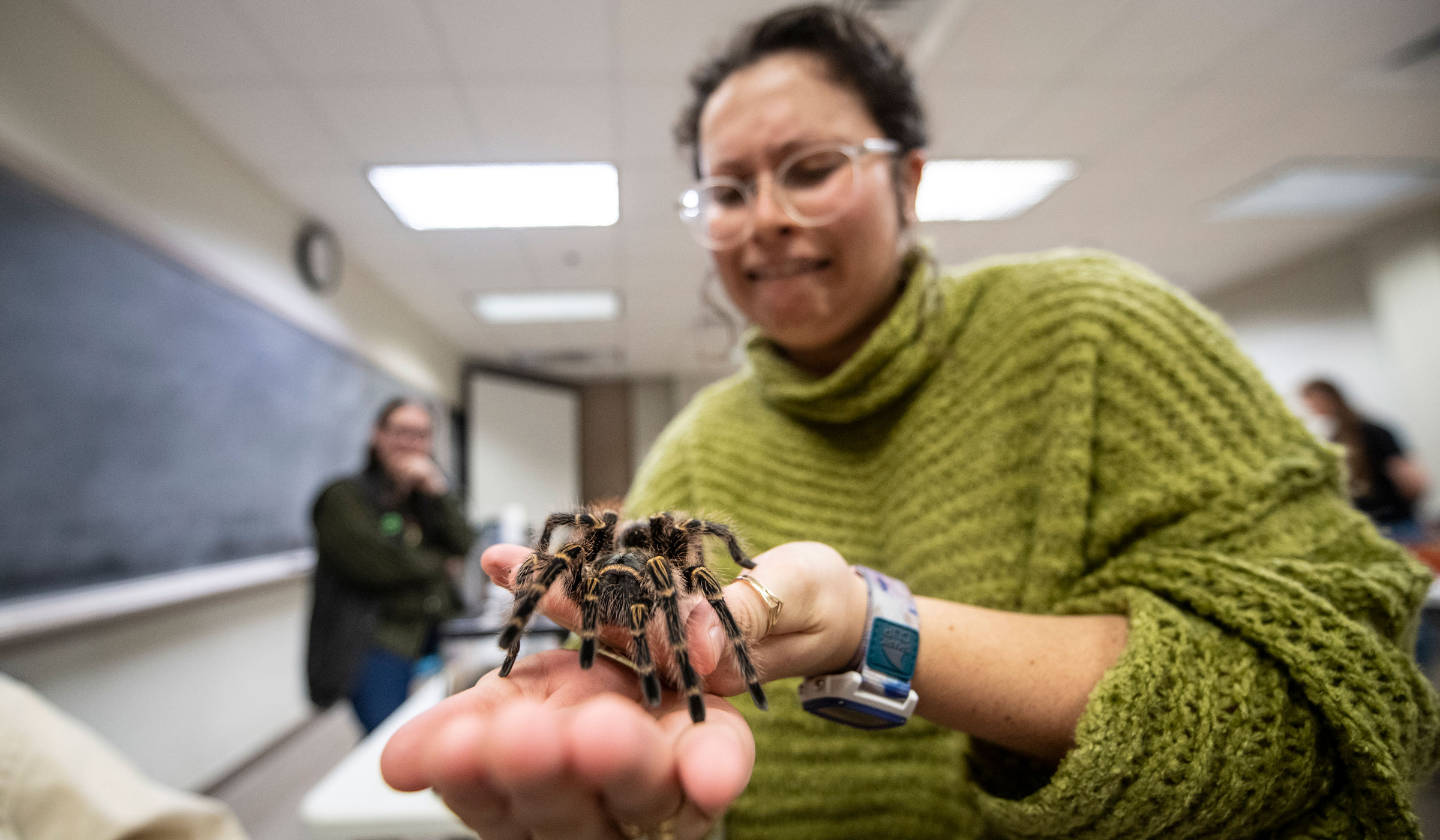 Nadia Nelson conquers her fear and holds one of Science Night's most famous attendees a tarantula named The Ambassador.