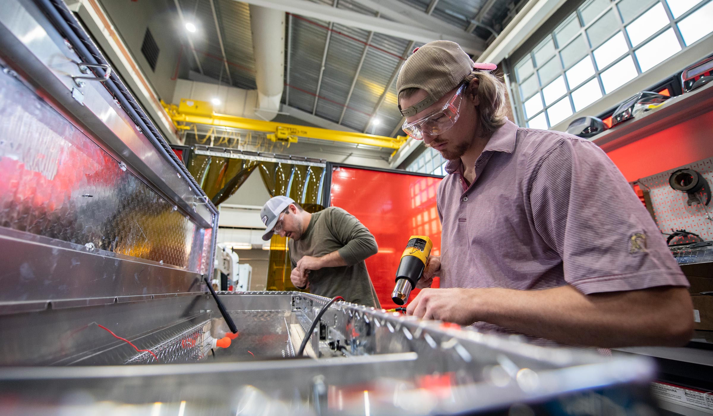 Two mechanical engineering students, Ryden Smith, right, of Tuscaloosa, and Wesley Cameron of Richton, work to convert a truck toolbox into a UV sterilization device at Mississippi State’s Center for Advanced Vehicular Systems. The device will be used to sterilize masks for MSU's Longest Student Health Center Staff, filling a need during the COVID-19 pandemic and a national shortage of masks.