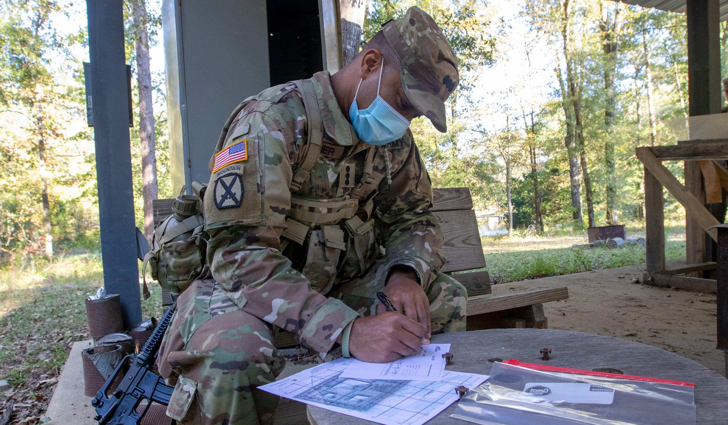 Army ROTC cadet and Senior Ethan Archer preparing his map before conducting a practical land navigation exam.
