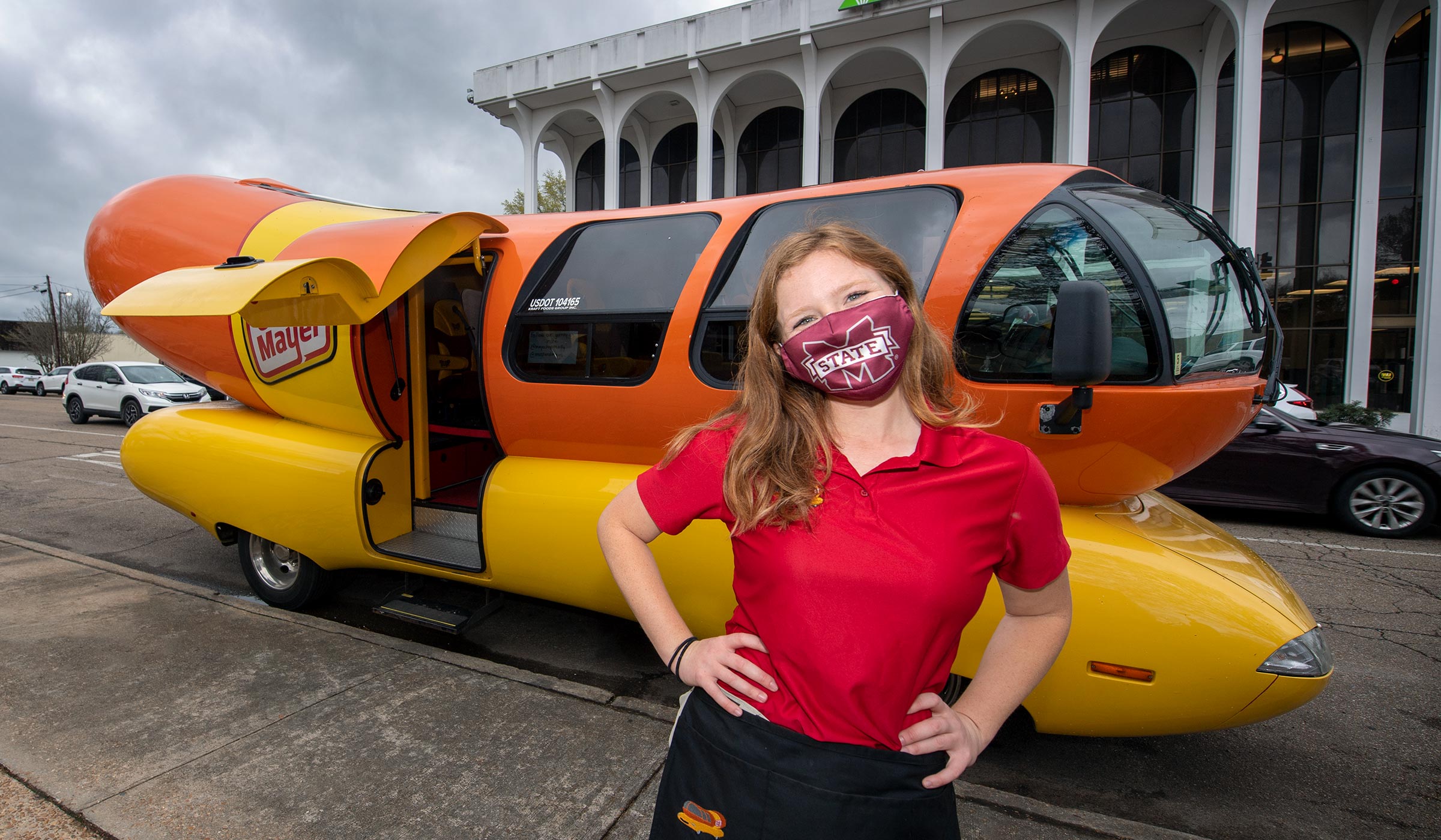 Broadcasting alum Maggie Thomas poses in front of the Oscar Meyer Weinermobile she drove to Starkville's Main Street.