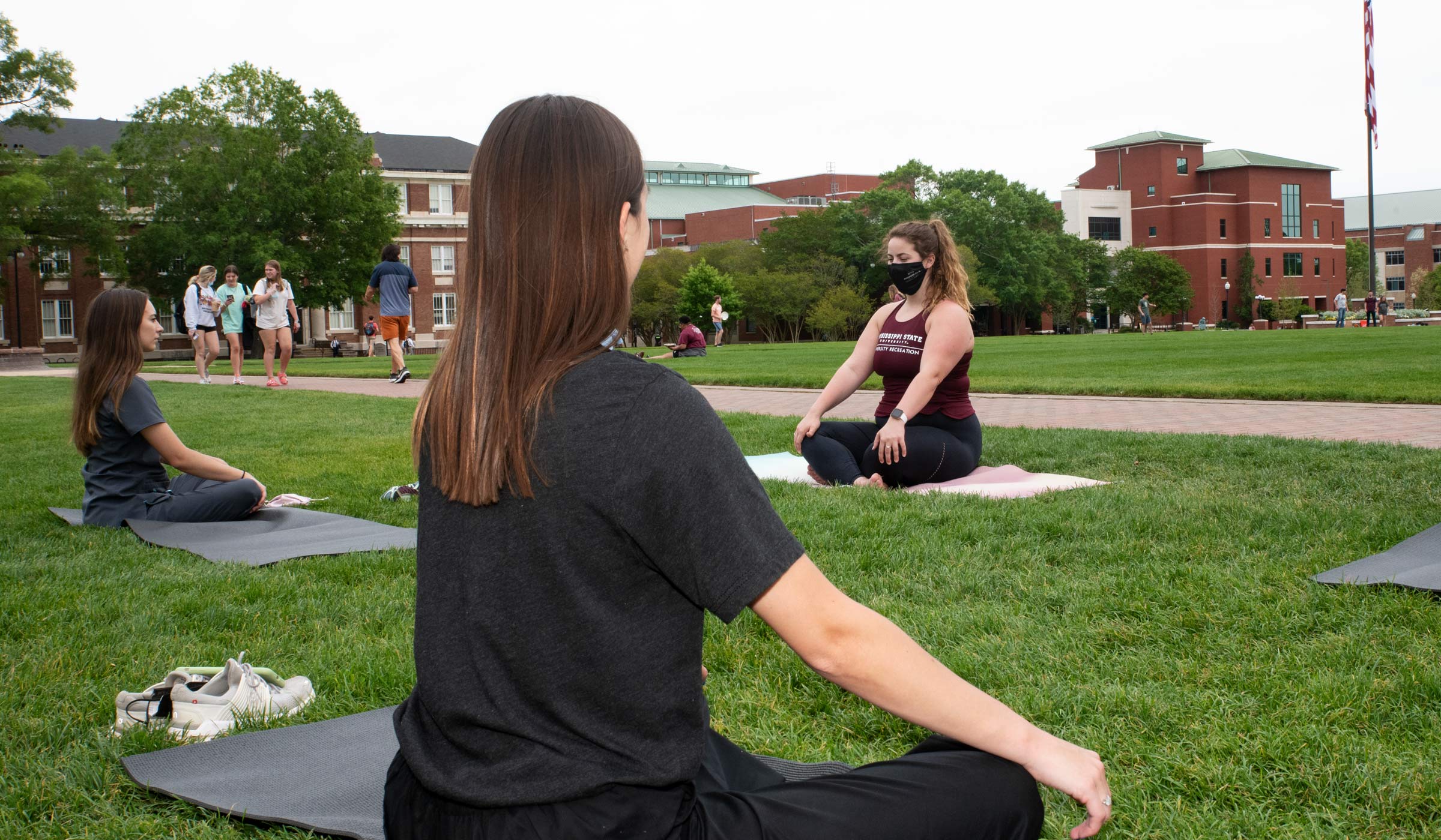 Jolie Kavanaugh instructs a yoga class during the Self-Care Fair held on the Drill Field (photo by Jarvis Mace / © Mississippi State University)