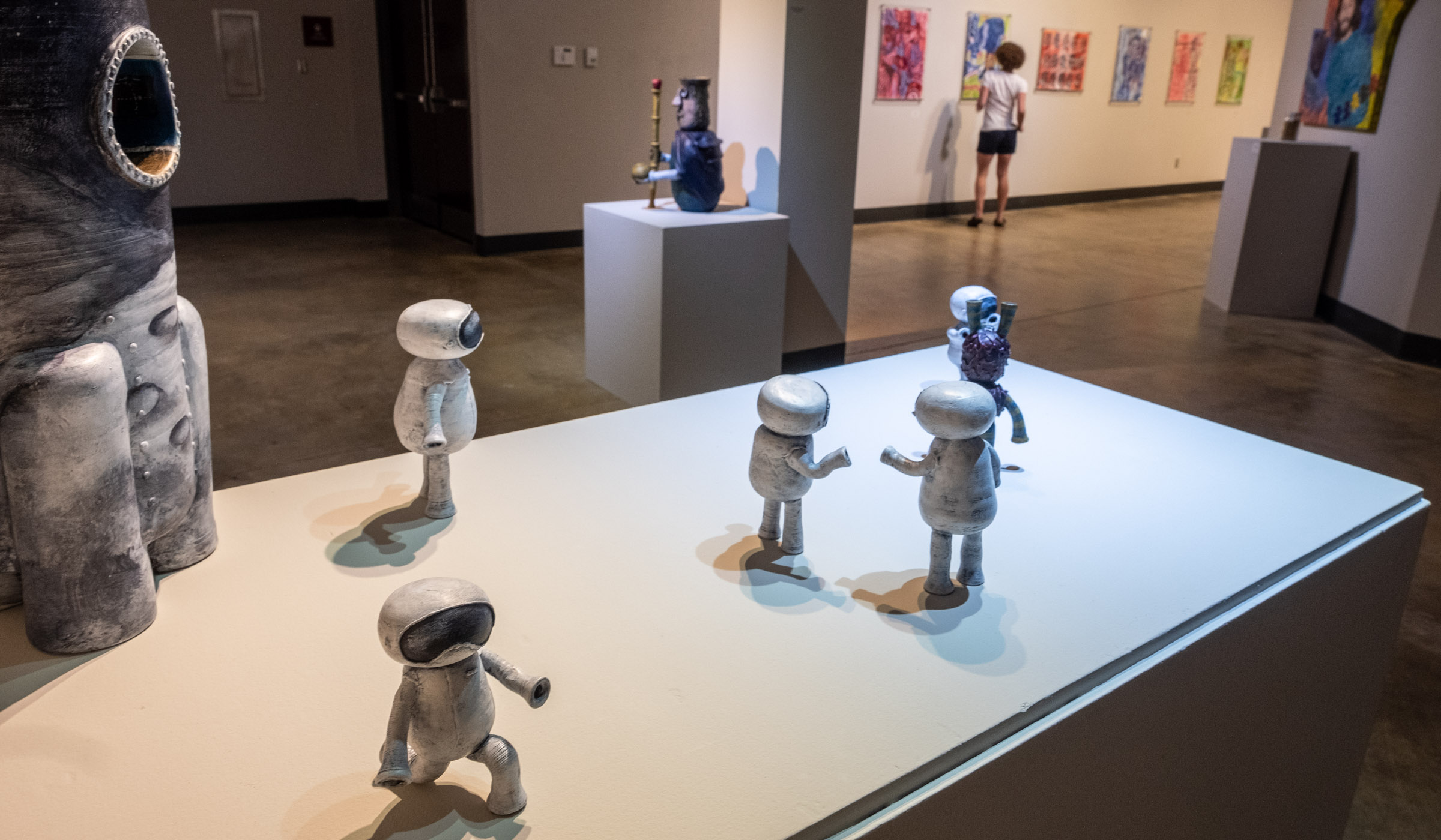 With views to other students' art on display in the background of the Culls Wade Art Gallery, clay