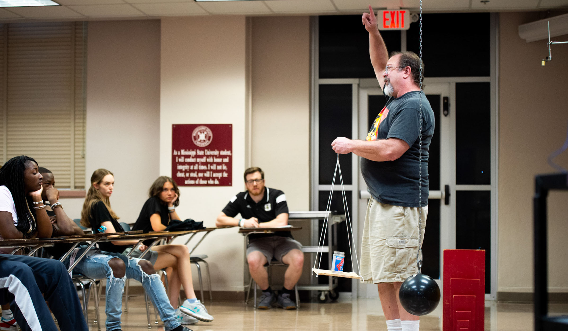 Dr. Jeff Winger, Professor in MSU's Department of Physics & Astronomy, conducts a physics exercise to a group of high school student