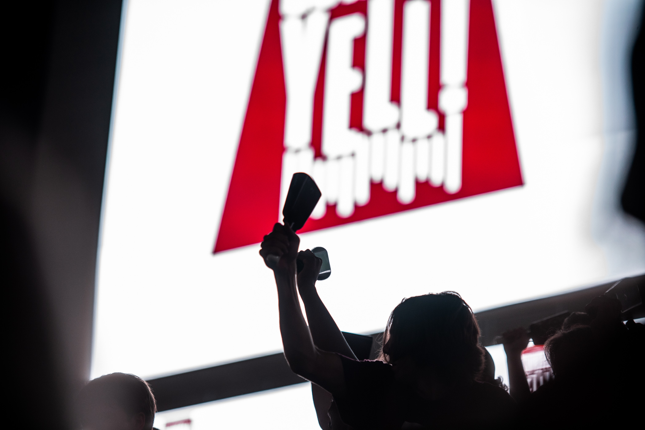 Cowbells held high silhouette against Davis Wade Stadium's jumbotron at the 2022 Cowbell Yell Pep Rally