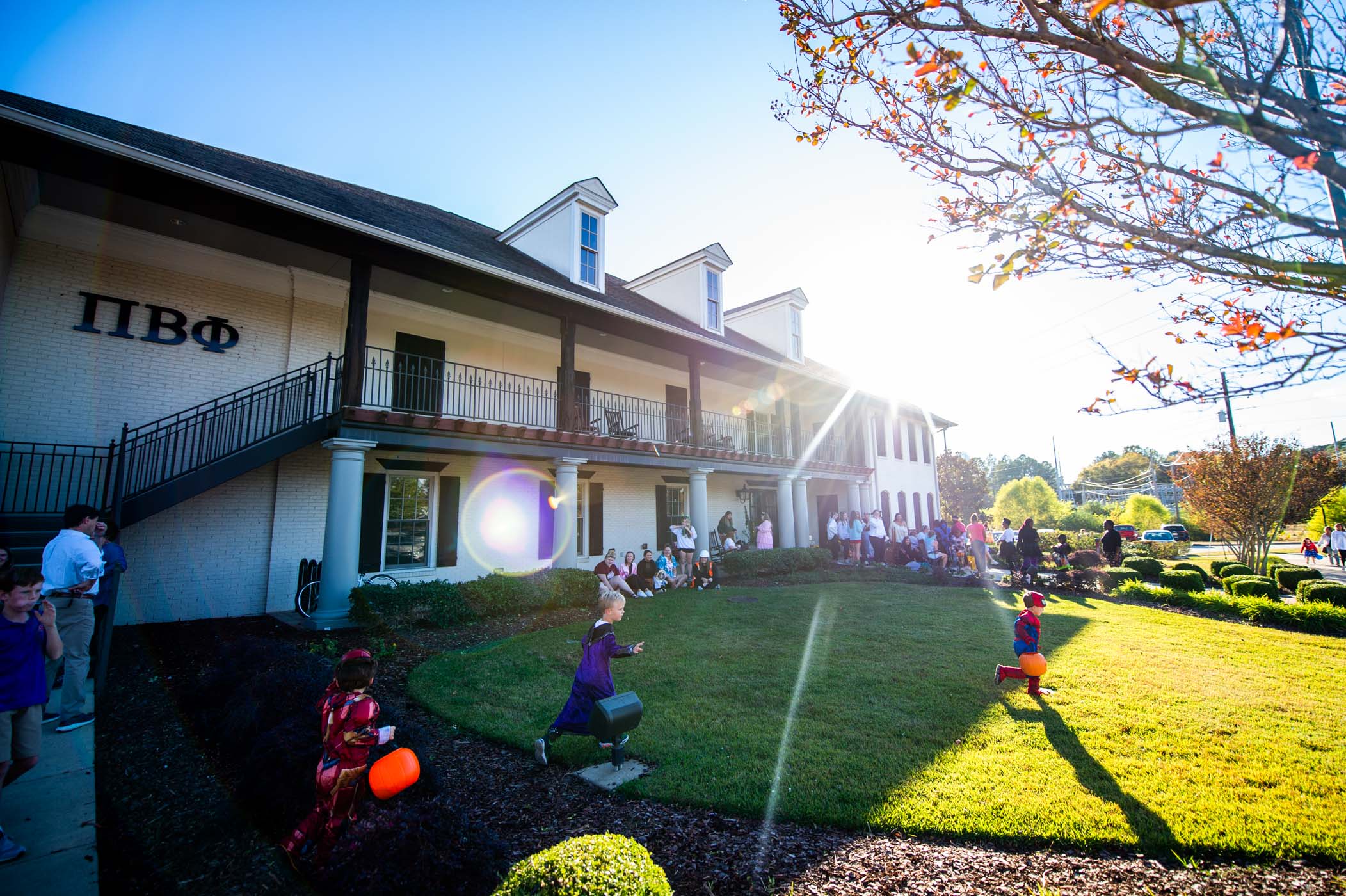 Happy Trick-or-Treater run across MSU Pi Beta Phi's front lawn to fill their treat buckets with candy from the Greek Life community