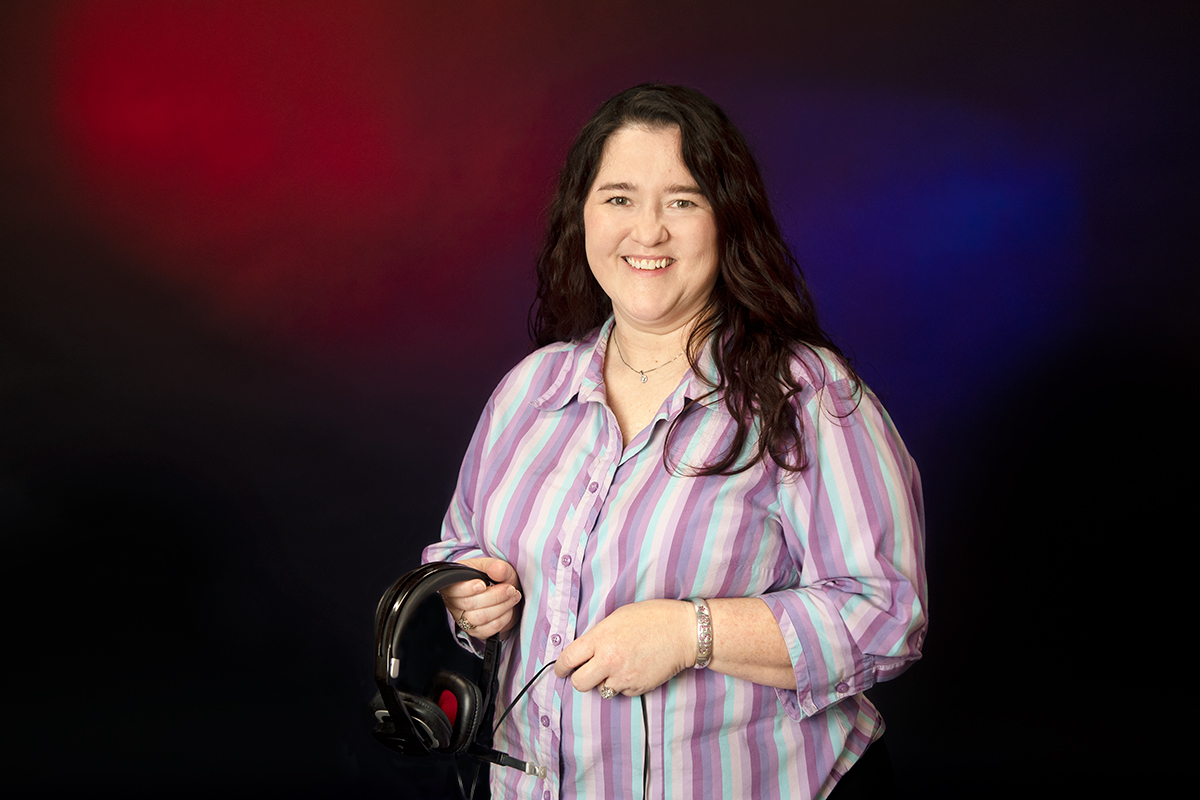 Tina Enlow, pictured holding dispatch equipment.