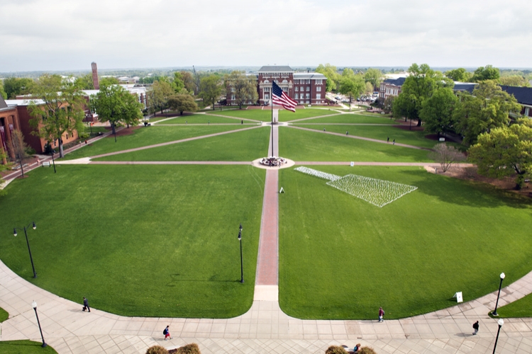 Graduate School Appreciation Week - flag cowbell on Drill Field
