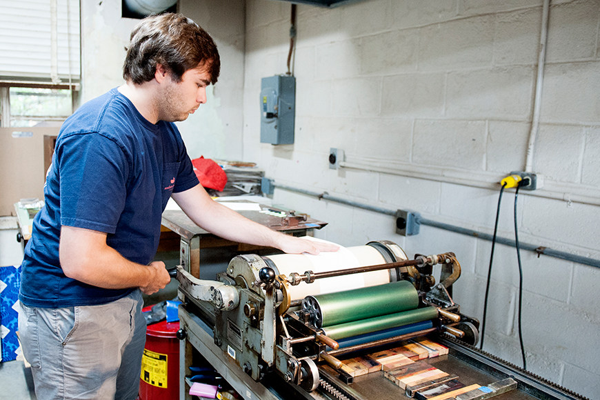 Mississippi State senior art/graphic design major Mitchell S. "Mitch" Phillips of Brandon works on a letterpress project in Assistant Professor Suzanne Powney's printing class.