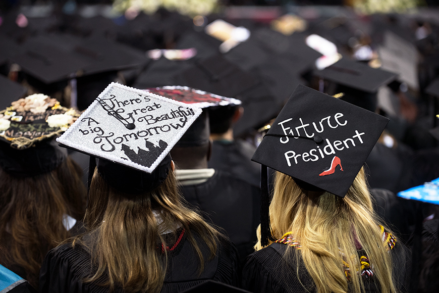 Decorated graduation caps with hopeful messages of "Future President" and "There's a Great Big Bright Tomorrow."