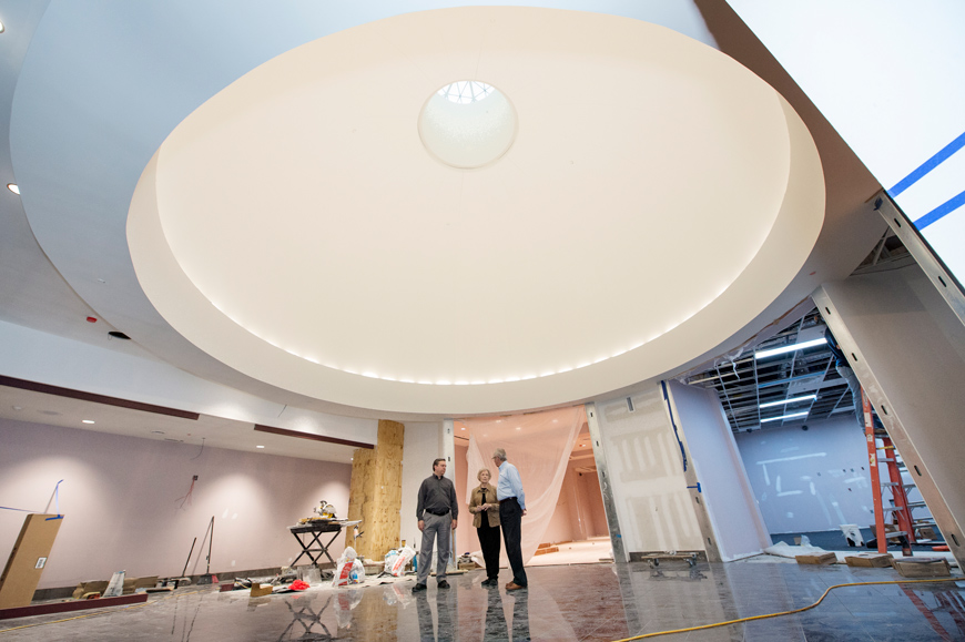 The Grant Presidential Library's big circular rotunda dwarfs the three figures as they tour the construction site.