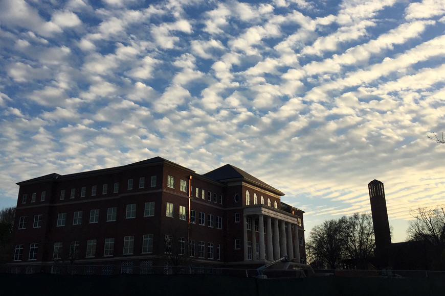 Sunset clouds dominate the sky over the "Old Main" Academic Center and Chapel Tower