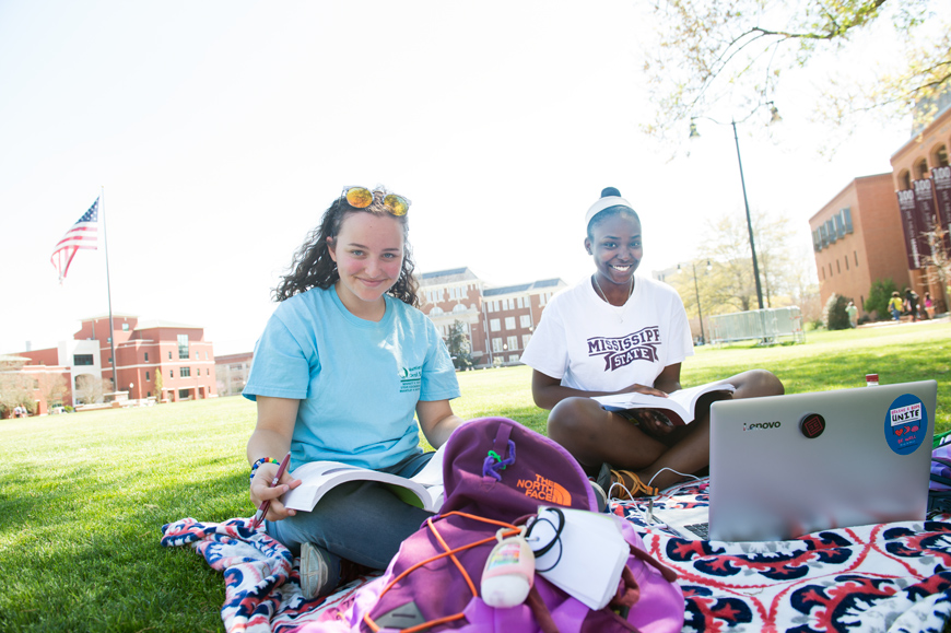 Friends Juliana Martinez and Quaneisha Clayton study on a Drill Field blanket on a a beautiful Spring Day.
