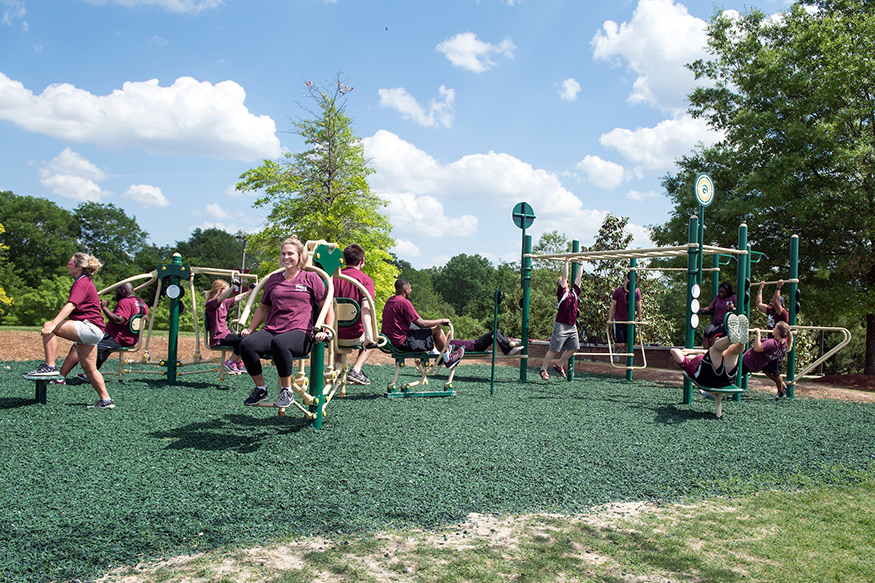 Mississippi State students demonstrate outdoor fitness equipment near the university’s Sanderson Center and Chadwick Lake. The equipment, made by Greenfields Outdoor Fitness Equipment, was installed as part of MSU on the Move, the university’s health and wellness initiative. The Blue Cross & Blue Shield of Mississippi Foundation provided nearly $1.5 million dollars to implement the MSU on the Move initiative to build a sustainable campus culture of health and wellness that reaches into the surrounding communities and schools. (Photo by Beth Wynn)