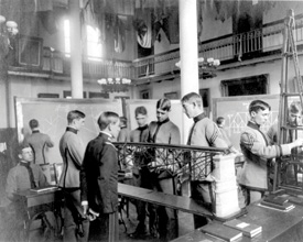 Early black and white photo of MSU students in a lab.